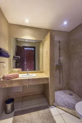 a bathroom with a sink and a shower at Apartment with Private Rooftop & Jaccuzzi in Marrakech