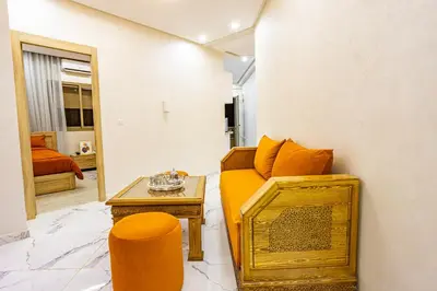 a living room with a couch and a table at HAGS Apartment - Traditional Modern Apartment, full AC, 10m from airport in Marrakech
