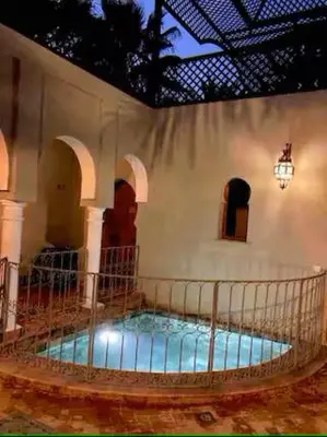 a room with a large pool in a building at Résidence AYDA Riad Villa Hanane in Marrakech