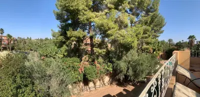a view from a balcony of trees and bushes at Villa Palmeraire Marrakech, Private pool, Private Hamam in Marrakech
