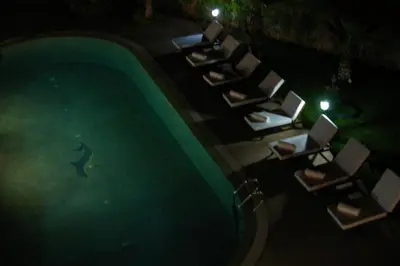 an overhead view of a swimming pool at night at Villa Palmeraire Marrakech, Private pool, Private Hamam in Marrakech