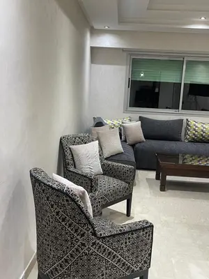 a living room with two chairs and a couch at LA PERLE ANDALOUSE Quartier HIVERNAGE in Marrakech