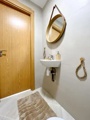a bathroom with a sink and a mirror at La perle d'atlas appartement in Marrakech