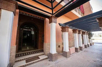 a building with white columns and an entry way at Elegant 2-BR, Pool And Parking Hivernage Centre in Marrakech