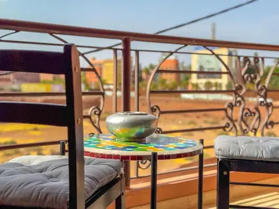 a bowl sitting on a table on a balcony at Elegant 2-BR, Pool And Parking Hivernage Centre in Marrakech