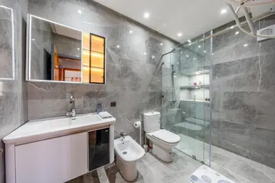 a bathroom with a toilet and a sink and a shower at L'essentiel au soleil piscine parking in Marrakech