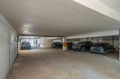 a parking garage with cars parked in it at L'essentiel au soleil piscine parking in Marrakech