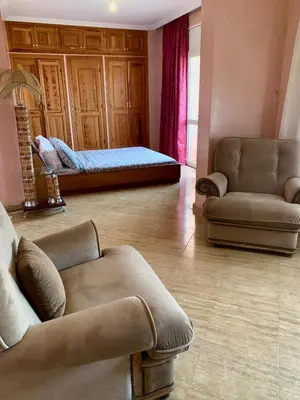 a living room with a couch and a bed at Appartement Gueliz in Marrakech