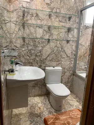 a bathroom with a toilet and a sink at Appartement Gueliz in Marrakech