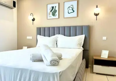 a bedroom with a large white bed with towels on it at havre de paix in Marrakech