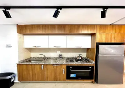 a kitchen with wooden cabinets and a stainless steel refrigerator at havre de paix in Marrakech
