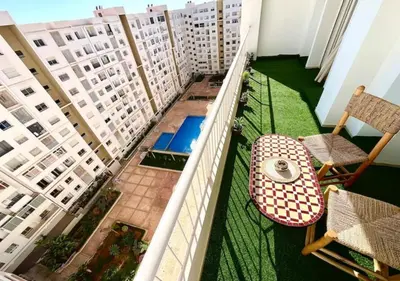 a balcony with a table and chairs and buildings at havre de paix in Marrakech
