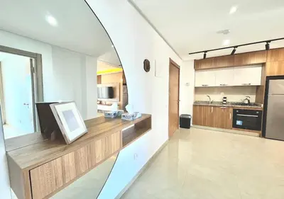 a living room with a large kitchen with a mirror at havre de paix in Marrakech