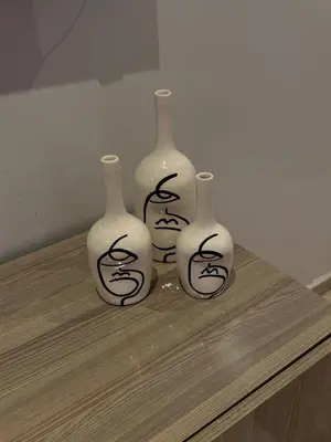 a group of three vases sitting on a table at Elegant Apartment Hivernage in Marrakech