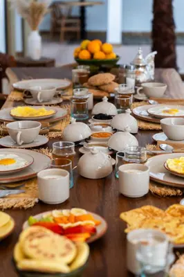 a long table with plates of food on it at Riad Dar Tonka in Marrakech
