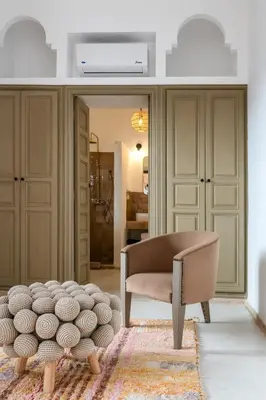 a living room with a chair and a rug at Riad Dar Tonka in Marrakech