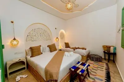 a bedroom with two beds in a room at Riad DAR ELMA NOI in Marrakech
