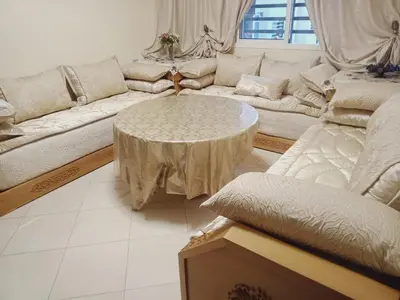 a living room with a couch and a table at Logement Confort Résidence Fermée avec Piscine in Marrakech