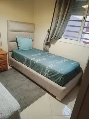 a small bed in a room with a window at Logement Confort Résidence Fermée avec Piscine in Marrakech