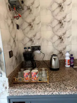 a kitchen counter with a tray with cups on it at Airport appartement , penthouse in Marrakech