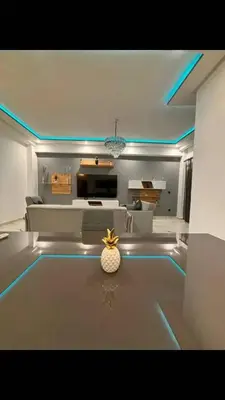 a living room with a vase sitting on a table at Appartement moderne in Marrakech
