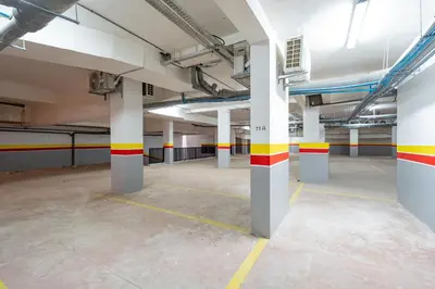 an empty parking lot with columns in a parking garage at Modern Studio in Hivernage with Pool Access in Marrakech