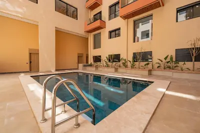 a swimming pool in the middle of a building at Modern Studio in Hivernage with Pool Access in Marrakech