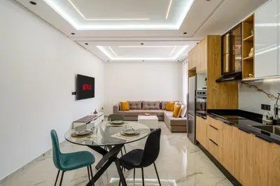 a kitchen and living room with a table and chairs at Modern Studio in Hivernage with Pool Access in Marrakech