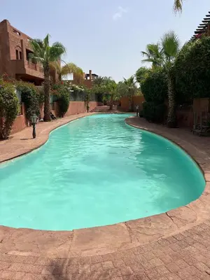 a large swimming pool with blue water at 4 Bed Villa lagune River Palm Marrakech with Pool in Marrakech