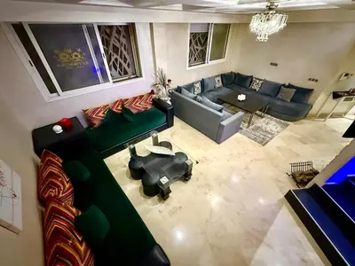 an overhead view of a living room with a couch and a table at Maison H&A in Marrakech