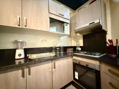 a kitchen with wooden cabinets and a blender at Maison H&A in Marrakech