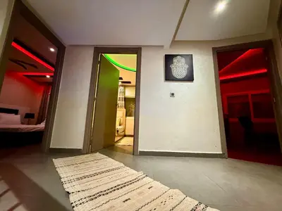 a room with doors and a rug on the floor at Maison H&A in Marrakech