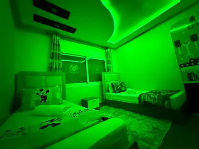 a green room with a bed and a bed at Maison H&A in Marrakech