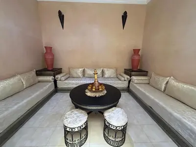 a living room with a couch and a table at Riad Marrakech in Marrakech