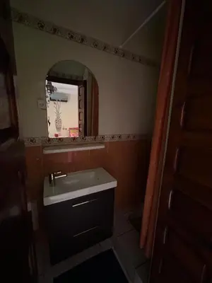 a small bathroom with a sink and a mirror at Riad Marrakech in Marrakech
