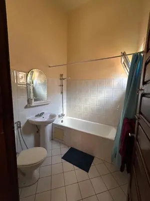 a bathroom with a tub and a toilet and a sink at Riad Marrakech in Marrakech