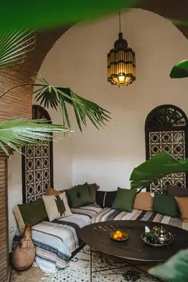 a living room with a couch and a table at Nahla Wellness in Marrakech