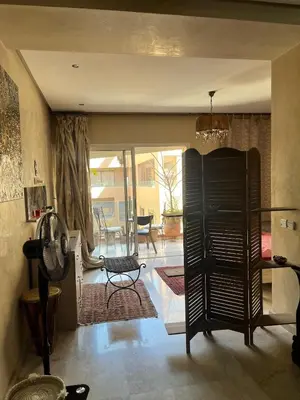 a living room with a view of a patio at nice apartment and good location in Marrakech