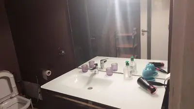 a bathroom with a white sink and a mirror at nice apartment and good location in Marrakech