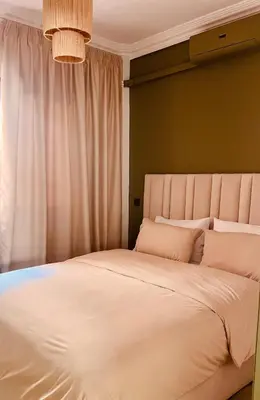 a bedroom with a large bed with white sheets at Bright Place and High Quality Mattress in Marrakech