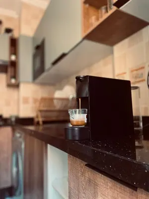a kitchen counter with a cup of coffee on it at Bright Place and High Quality Mattress in Marrakech