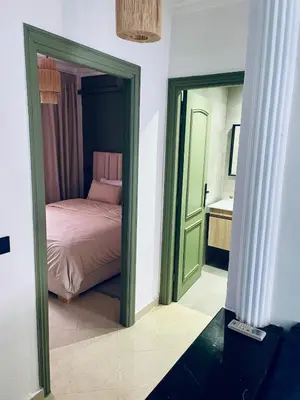 a bedroom with a bed and a mirror at Bright Place and High Quality Mattress in Marrakech