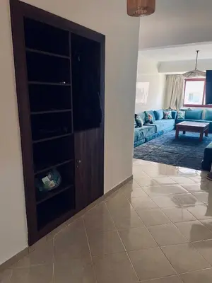 a living room with a entertainment center and a tv at Bright Place and High Quality Mattress in Marrakech