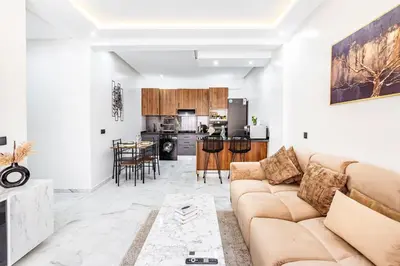a living room with a couch and a kitchen at Cocoon in Gueliz, Netflix, IPTV in Marrakech