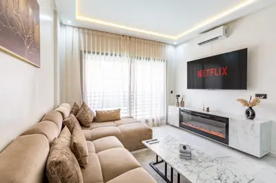 a living room with a large couch and a tv at Cocoon in Gueliz, Netflix, IPTV in Marrakech