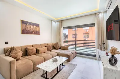 a living room with a couch and a table at Cocoon in Gueliz, Netflix, IPTV in Marrakech