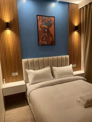 a bedroom with a large bed with a blue wall at A Thousand and One Night Dream in Marrakech in Marrakech