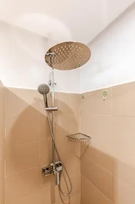 a shower with a shower head in a bathroom at A Thousand and One Night Dream in Marrakech in Marrakech