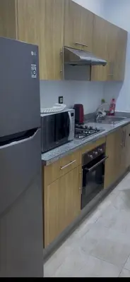 a kitchen with a microwave oven and a refrigerator at A Thousand and One Night Dream in Marrakech in Marrakech