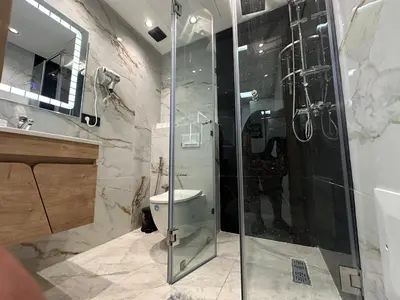 a bathroom with a shower and a toilet at Aube Hivernage appartement in Marrakech